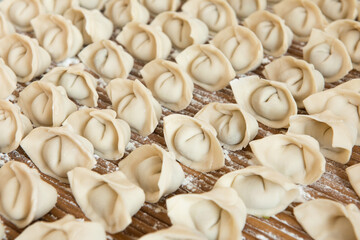 Raw dumplings background. Cooking dumplings in the kitchen.