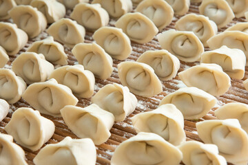 Raw dumplings background. Cooking dumplings in the kitchen.