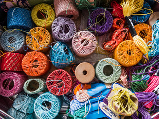 sewing box with threads of various colours and sizes