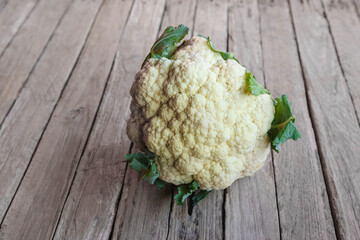 Cauliflower vegetables on wooden background