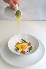 Chef serving cream from above the dish