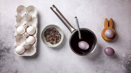 Process of dyeing Easter eggs with natural dye. Color produced from seeds of woad (isatis tinctoria). Top view.