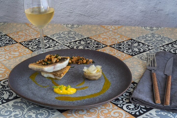 Grilled sea bream on gray dish