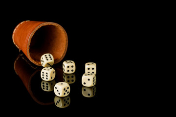 dice with reflection on black background, copy space