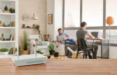 Modem and router box on the table and living room background blur concept.