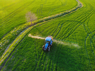 Aerial view of modern farm machine sprayer on green field. Modern technology of agriculture