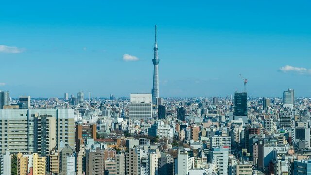 time lapse video of aerial view of Tokyo city skyline a capital city of japan and city of Tokyo Olympic 2021 with blue sky