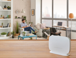 Modem and router box on the table and living room background blur concept.