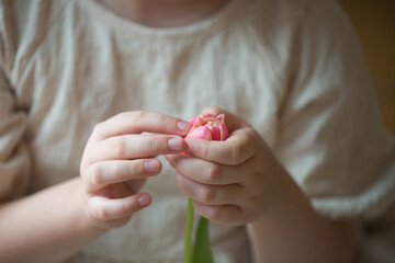 child holding a rose