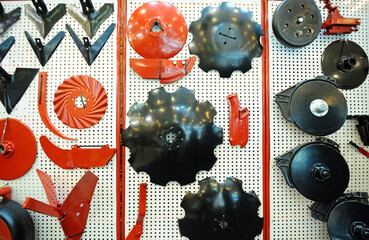 Parts of harrow, seeding mashines and cultivators presentesd on stand.