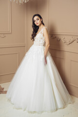 Fashion bride in gorgeous wedding dress studio portrait. Beautiful model with bridal makeup and hairstyle in marriage lace dress.