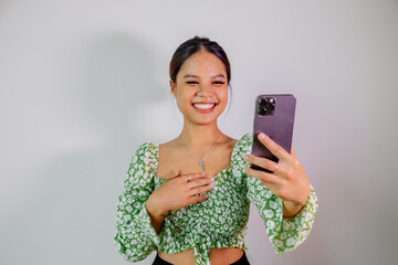 Pretty asian girl take a self portrait with her smart phone. Thai girl selfie.