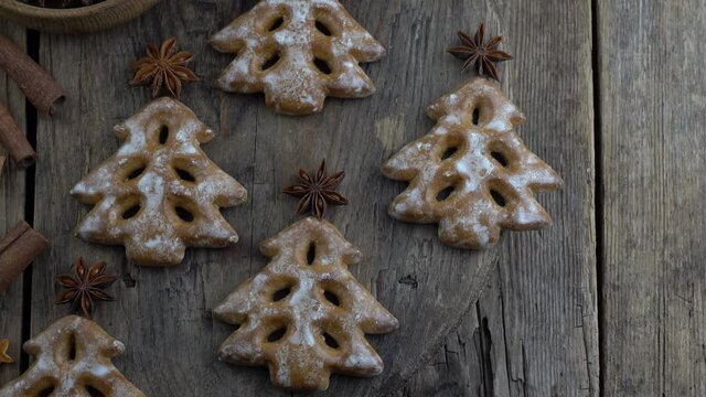 Christmas tree cookies on wooden background. New Year's food. Anise star. Festive baked goods. Gingerbread on the table.Icing sugar sweetness taste season.
