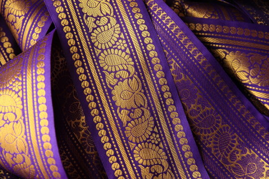 Purple violet Indian Sari border with gold paisley pattern. purple background