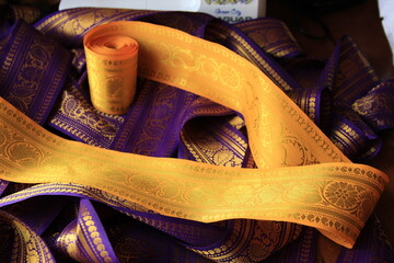 Purple violet and yellow Indian Sari border with gold paisley pattern. purple yellow background