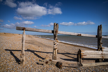Old wooden groynes at Rye Harbour, East Sussex, England