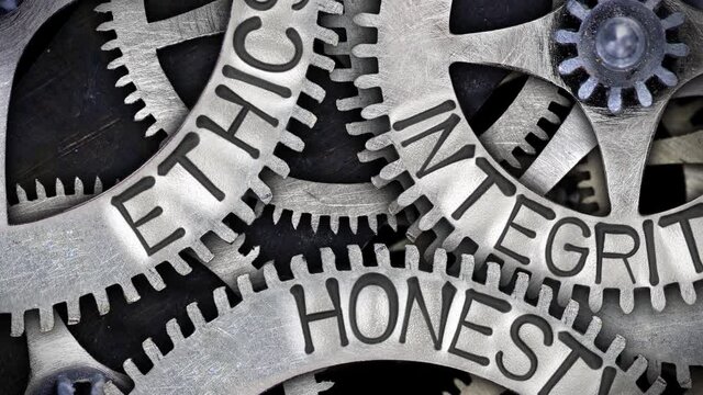 Group of rotating tooth wheels with Ethics, Honesty and Integrity sign imprinted on metal surface. High quality 4k video.
