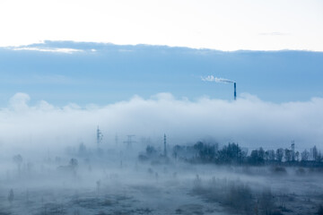 Dark industrial cityscape. Incinerator Factory pipe polluting air, smoke from chimneys. Environmental problems, ecological theme, industry scene. Black and white photo