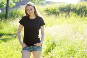 Naklejka na ściany i meble Beautiful girl wears t-shirt in black with text space or copy space for print, design or logo 