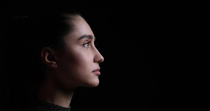 Profile face of beautiful woman on black background