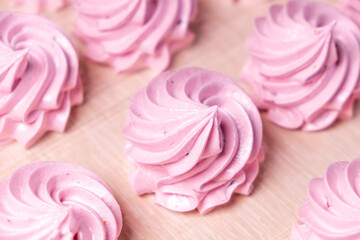 Fototapeta na wymiar Handmade pink marshmallows on parchment background. Marshmallow, Meringue. Homemade Sweets dessert