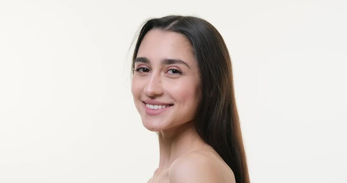 Profile face of beautiful woman smiling over white background