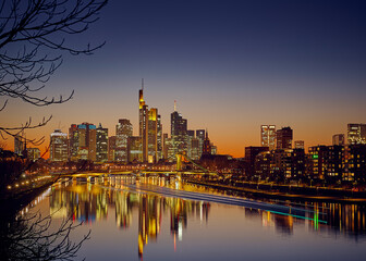 Frankfurt am Main city skyline after sunset with trace of a boat