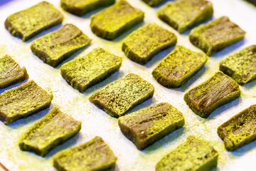 Close up of matcha green tea powder on mochi, thai street food market