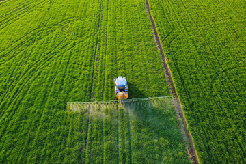 Aerial view of modern farm machine sprayer on green field. Modern technology of agriculture	