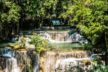 Fototapeta na wymiar beautiful tropical deep rainforest waterfall Fresh turquoise waterfalls in deep forest of Huay Mae Khamin waterfall in the national park Beautiful landscape waterfalls 