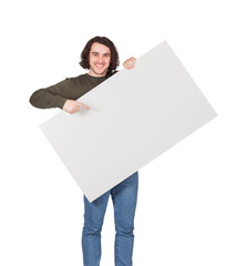 Contented young man holding a big blank banner for advertising pointing and showing with index finger. Happy guy with an empty sheet for text announcements as a lottery winner with bank check prize - 422567666