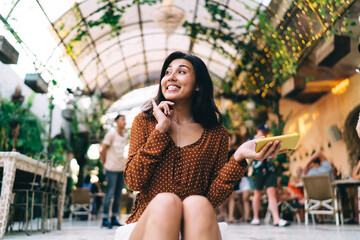 Satisfied woman messaging in crowded place