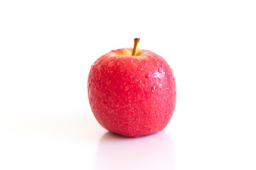 Bright red apples and water droplets on the apple surface are placed on a white background.
