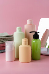 Set of cosmetic skin care products, facial product, skincare blank bottle packaging on pink background. Beauty and spa concept.