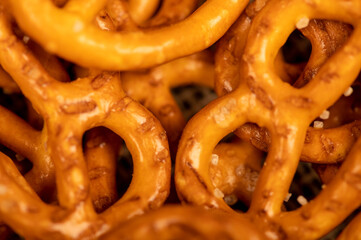 Salted breadsticks and salted pretzels scattered on the table.