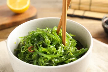 Foto op Canvas Japanese seaweed salad with chopsticks served on table, closeup © New Africa
