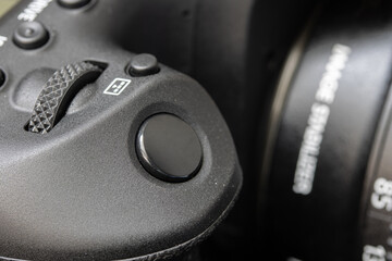 The shot button of a digital photo camera, close up.