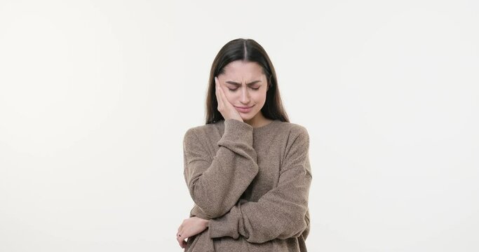 Woman suffering from toothache over white background