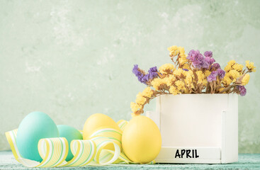 cube calendar for easter on table decorated with colorful eggs