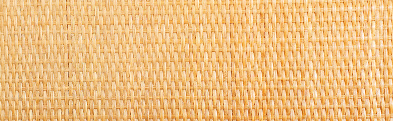 Yellow rattan texture. Copy space. Close up