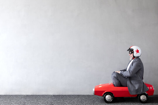 Senior businessman against concrete wall with copy space