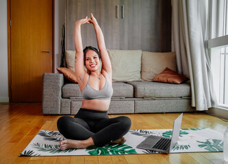 Young Asian healthy woman workout at home, exercise looking at videos, fit, doing yoga, plank, abs, meditation. Bodyweight floor exercises. Healthy lifestyle. Home fitness concept
