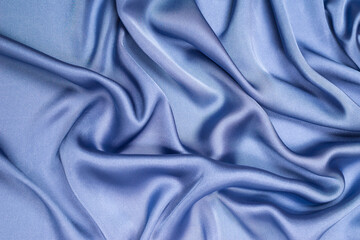 Blue silk or satin luxury fabric texture. Top view.