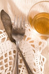 Tarnished silverware and a glass.