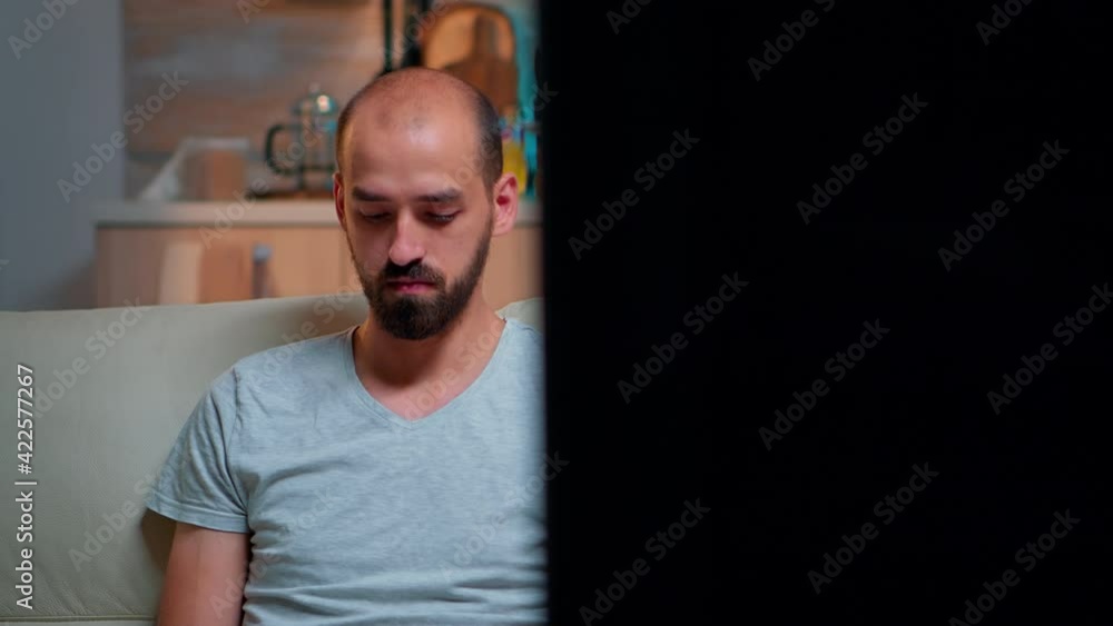 Poster focused man browsing on internet information for deadline project using laptop computer while sittin
