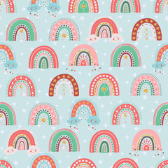 Fototapeta premium Hand drawn seamless pattern of cute rainbows with star, heart, cloud, moon. Colorful adorable doodle sketch illustration for greeting card, invitation, wallpaper, wrapping paper, fabric, baby room