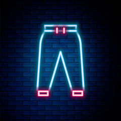 Glowing neon line Sport pants icon isolated on brick wall background. Colorful outline concept. Vector