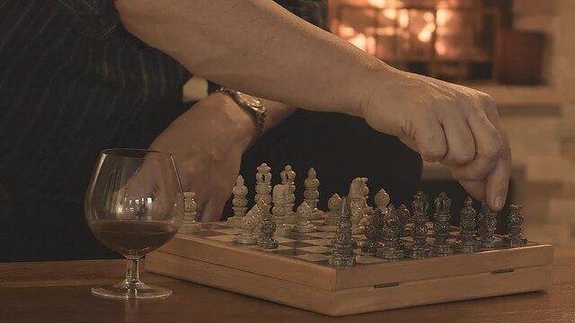 Game of Chess. Close Up of Hand Confident Businessman moving a pawn.