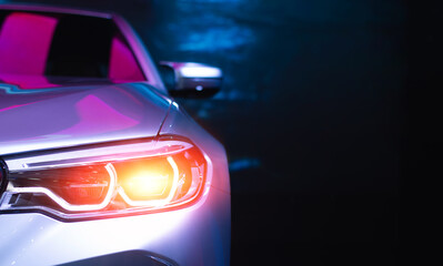 Fototapeta na wymiar Headlight lamp of new cars,Close up detail on one of the LED headlights modern car.