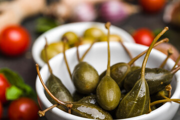 Capers. Marinated cooking ingredients. Mediterranean food background.